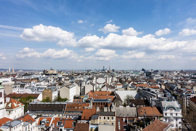 Cityscape against cloudy sky