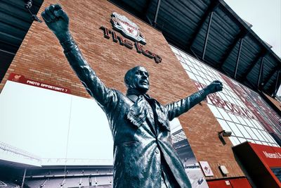 Low angle view of statue in city against sky