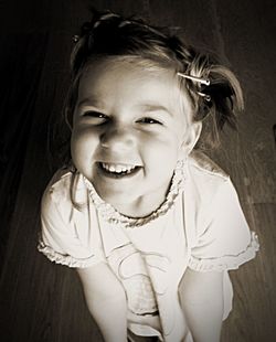 High angle portrait of smiling girl standing at home