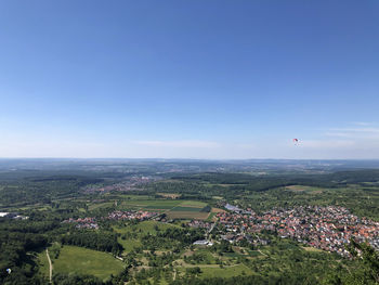 Aerial view of city against clear blue sky