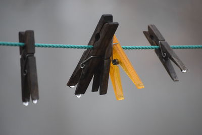 Close-up of pegs on washing line against clear sky