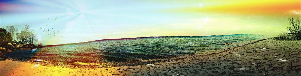 Scenic view of beach against sky during sunset