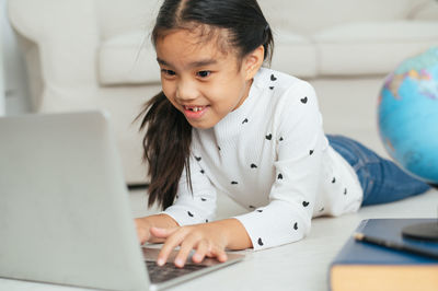 Portrait of cute girl using mobile phone