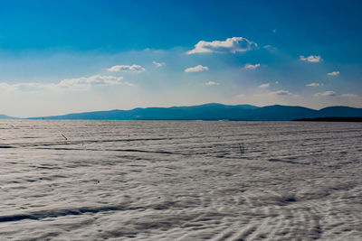 Scenic view of landscape against blue sky