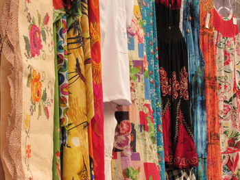 Colorful clothes hanging in store for sale