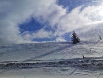 Scenic view of snow covered landscape against sky