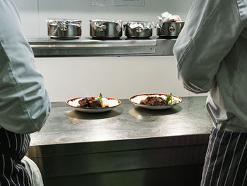 Midsection of man preparing food in kitchen