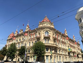 Low angle view of buildings against blue sky