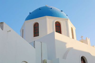 Low angle view of white building against clear blue sky