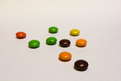 High angle view of candies against white background