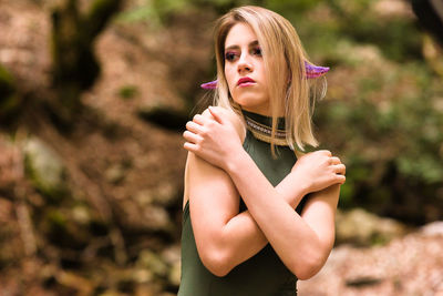 Portrait of beautiful young woman standing outdoors