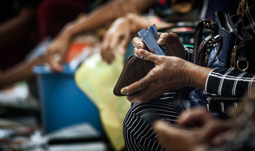 Close-up of senior woman holding wallet