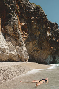 Woman on rocks by sea