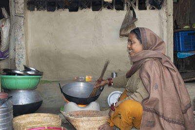 Side view of woman preparing food at home