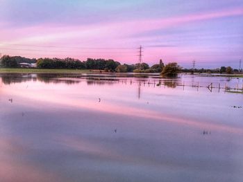 Scenic view of lake against sky at sunset