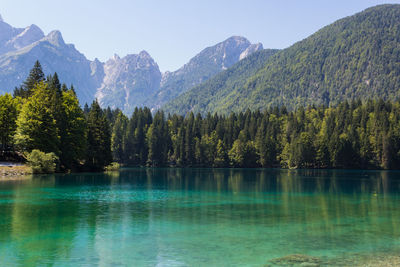 Scenic view of lake and mountains against clear sky