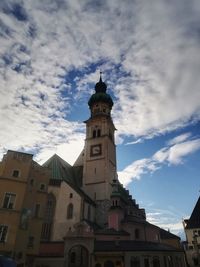 Low angle view of clock tower amidst buildings in city