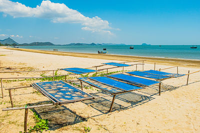 Scenic view of beach against blue sky