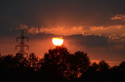 Low angle view of silhouette trees against sky during sunset