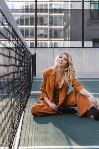 Portrait of smiling young woman sitting outdoors