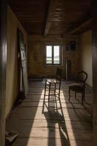 Empty chairs and table in building