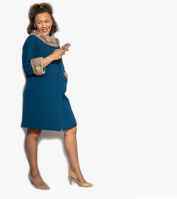 Portrait of a smiling young woman against white background