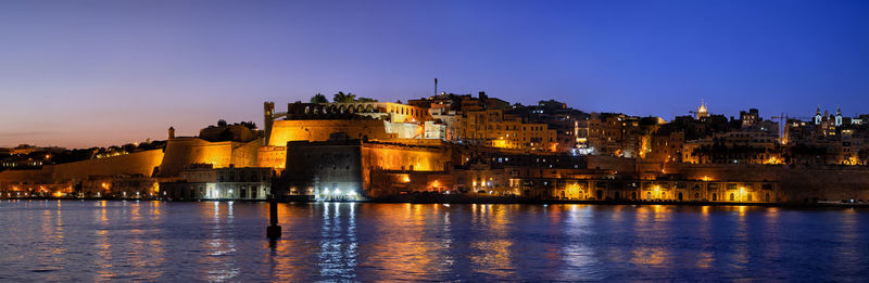 Illuminated buildings at waterfront