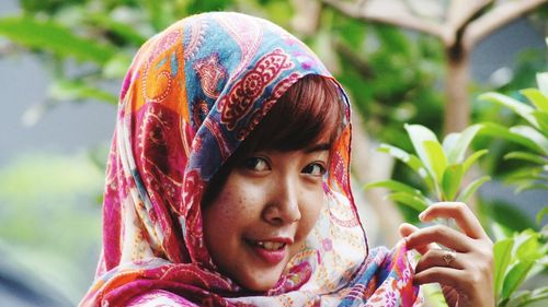 Close-up portrait of a smiling young woman