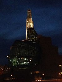 Low angle view of modern building against sky at night