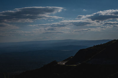 Scenic view of sea and mountains against sky