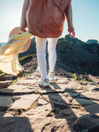 Low section of women standing on rock