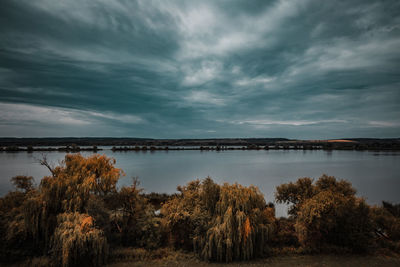 Scenic view of lake against sky during sunset