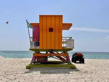 Lifeguard hut on beach against clear sky
