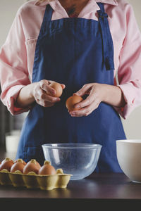 Midsection of man preparing food on table at home