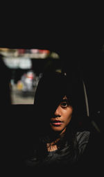 Portrait of young woman in car