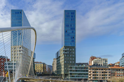 Modern buildings in city against sky