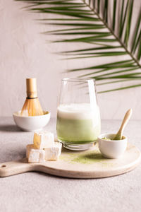 Green tea matcha latte on a white stone board