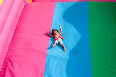Chilf sliding down on a bouncy castle