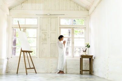 Woman standing in corridor of building