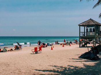 People relaxing on beach