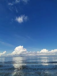 Scenic view of sea against blue sky with cloud