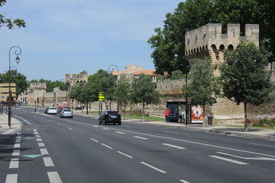 Vehicles on road along buildings