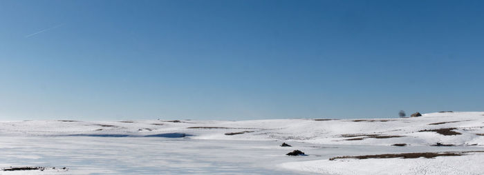 Snow covered mountain against clear blue sky