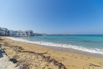 Scenic view of beach against clear blue sky