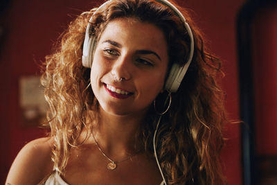 Woman listening music while sitting at home
