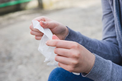 Cropped image of woman holding tissue paper