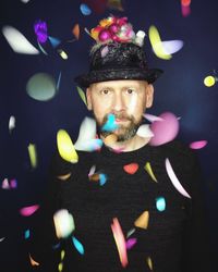 Close-up portrait of man by confetti in party