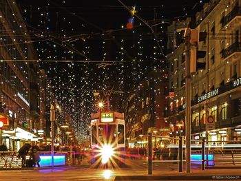 Illuminated city against sky at night