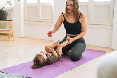 Portrait of young woman exercising at home