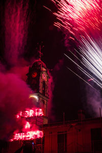 Low angle view of firework display at night